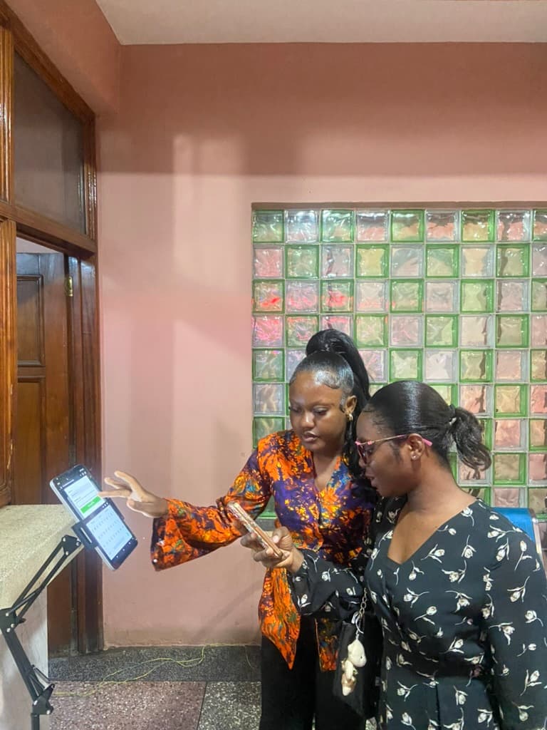 Attendees receiving help at the welcome desk